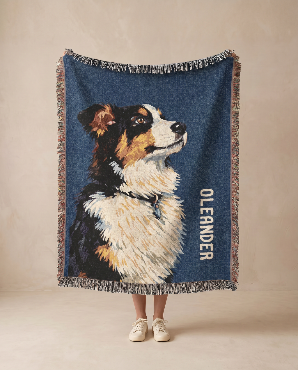 Custom throw blanket with an  Australian Shepherd dog illustration and 'Oleander' text on a beige background