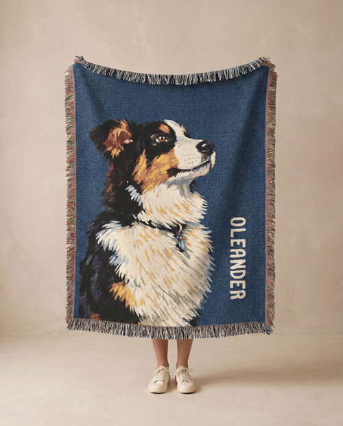 Custom throw blanket with an  Australian Shepherd dog illustration and 'Oleander' text on a beige background