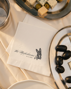 a table scape for a back tie wedding with cocktail napkins with pet, olives on trays
