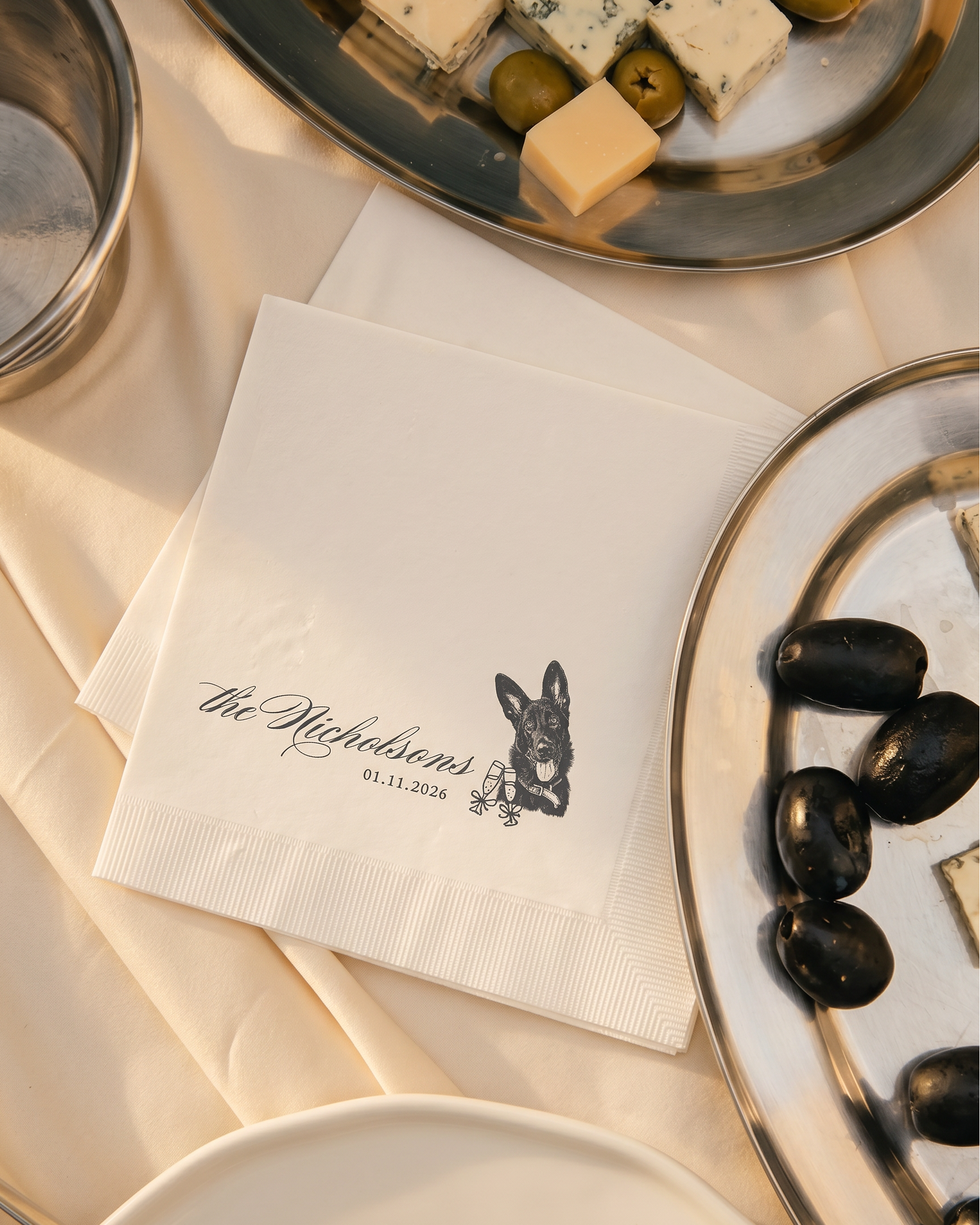 a table scape for a back tie wedding with cocktail napkins with pet, olives on trays