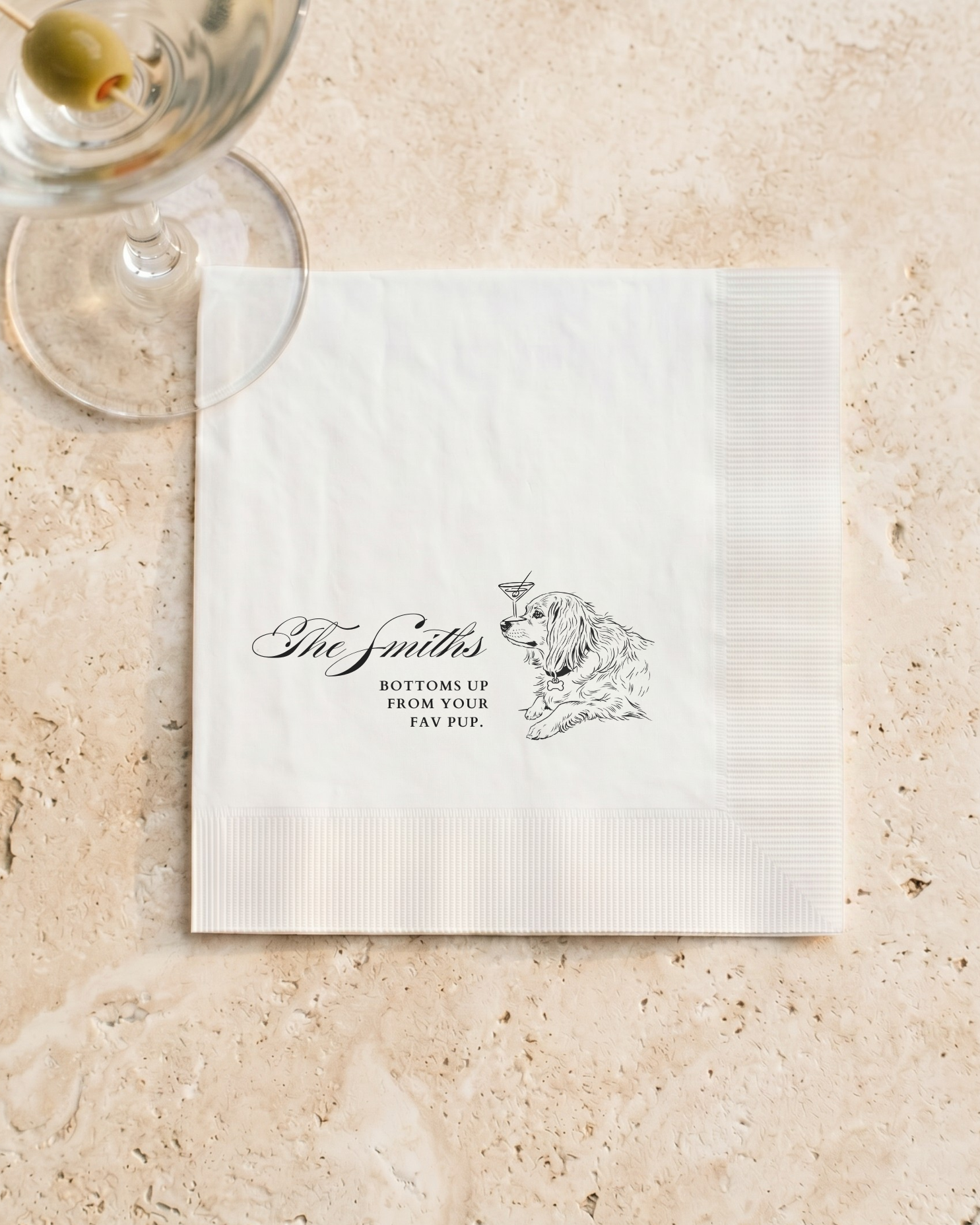 cocktail napkin with dog illustration and text on a beige surface