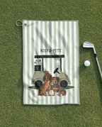 Golf towel with dachshunds and golf cart design on a green surface