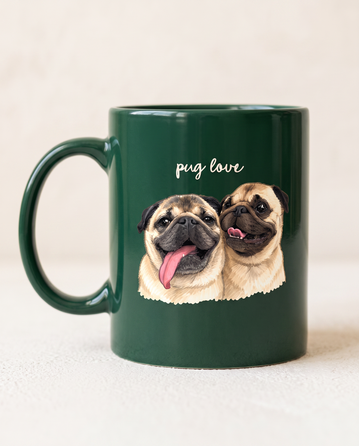 A dark green ceramic mug with a handle, featuring a printed illustration of two pug dogs and the text 'pug love' in white script on the front, set against a light beige background.