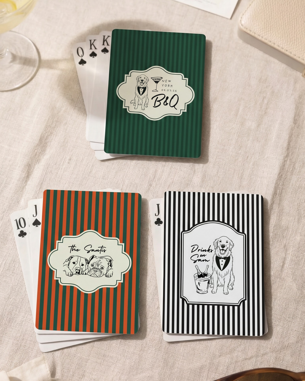 Set of playing cards with decorative covers on a light fabric background