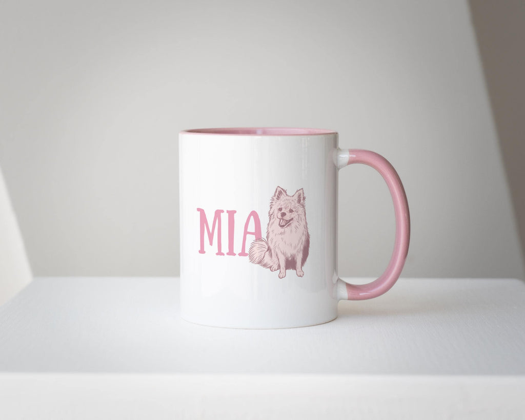 White mug with pink handle featuring a dog illustration and text on a white background