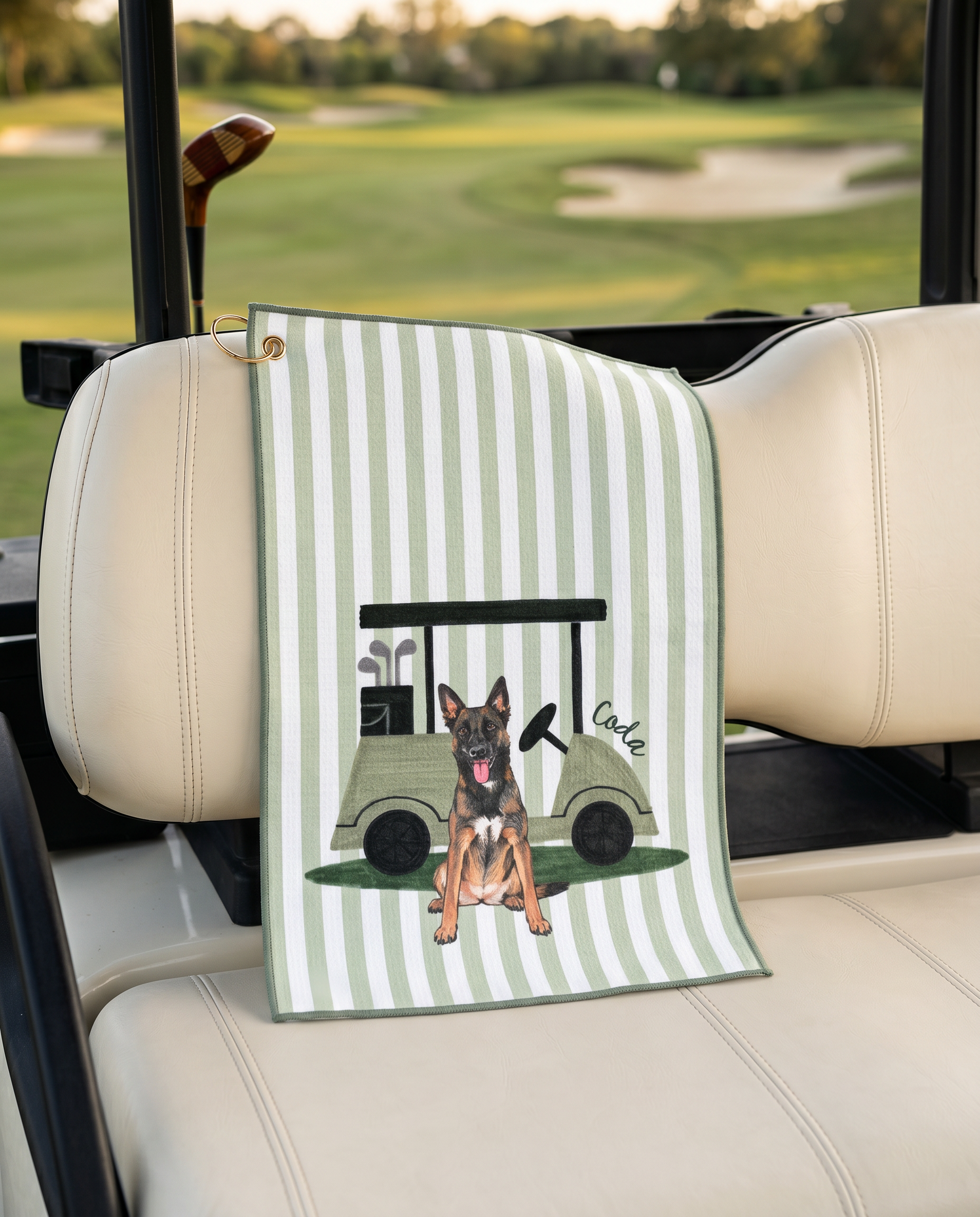 Golf towel with a dog and golf cart design on a car seat