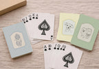 Playing cards with dog illustrations on a wooden surface
