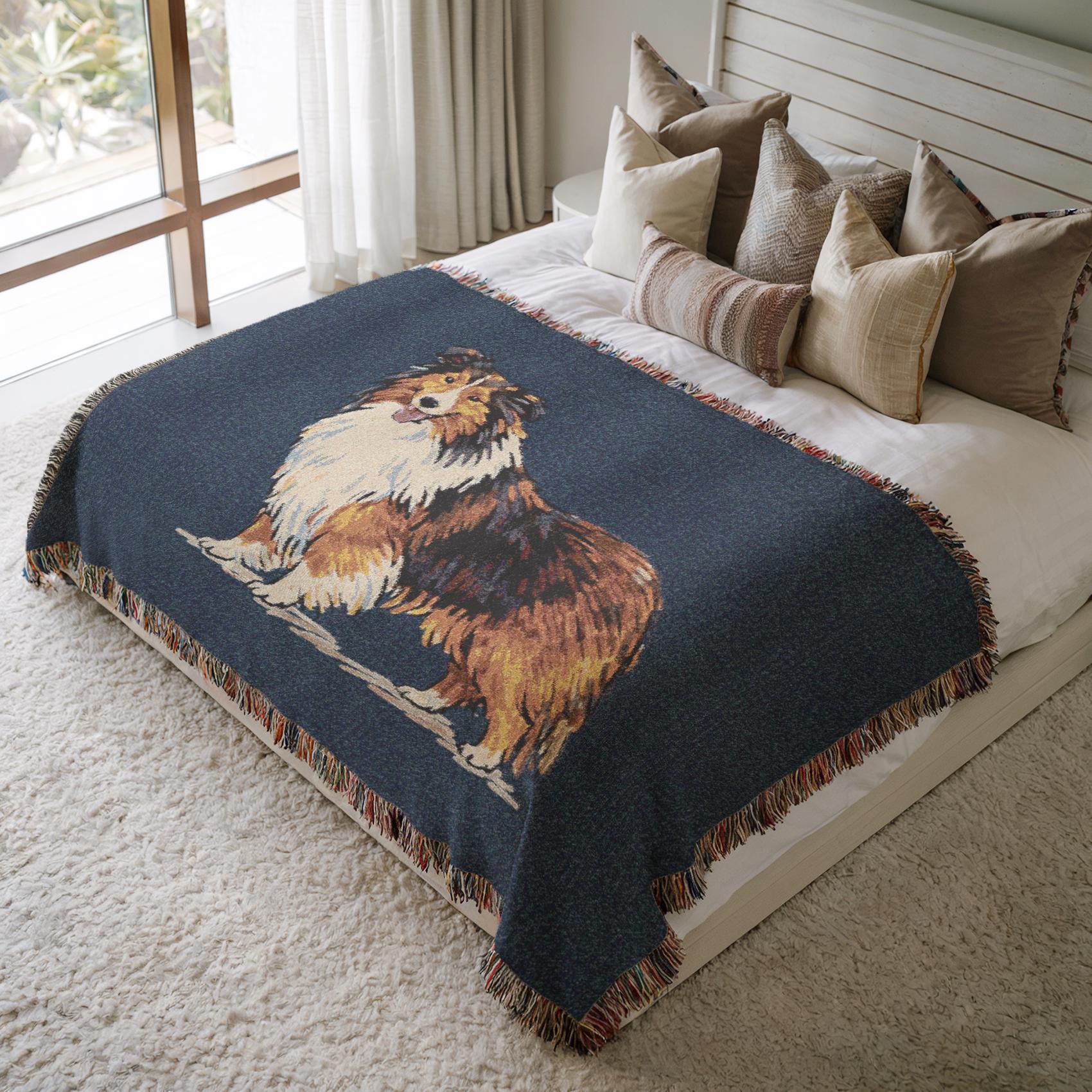 Bed with a decorative blanket featuring a dog design, surrounded by pillows in a well-lit room.