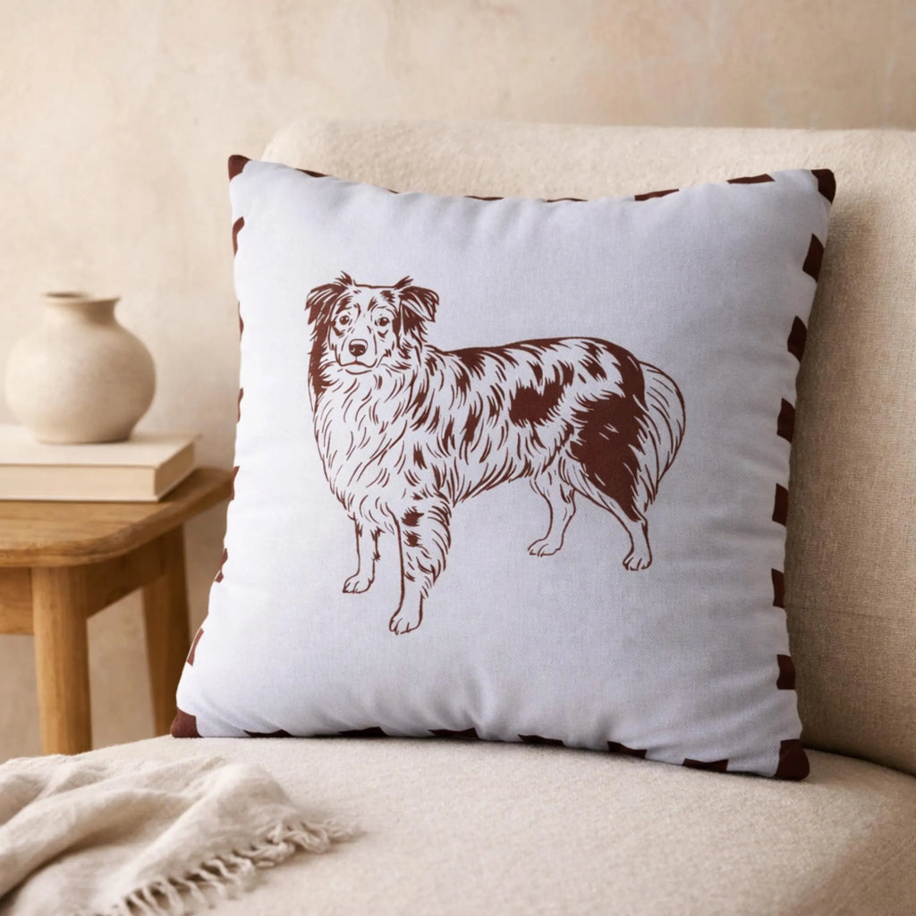 Decorative pillow with a brown dog illustration on a beige couch.