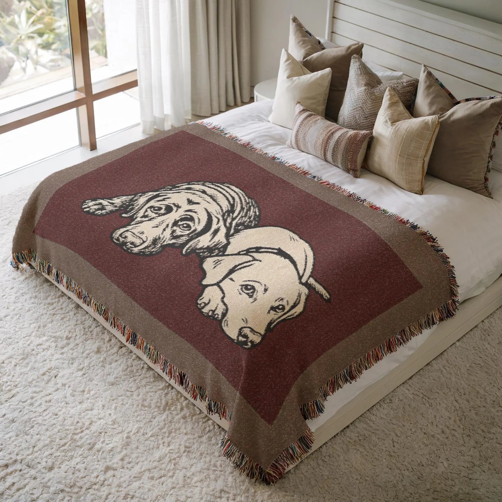 Bed with a decorative blanket featuring dog illustrations in a bedroom setting.