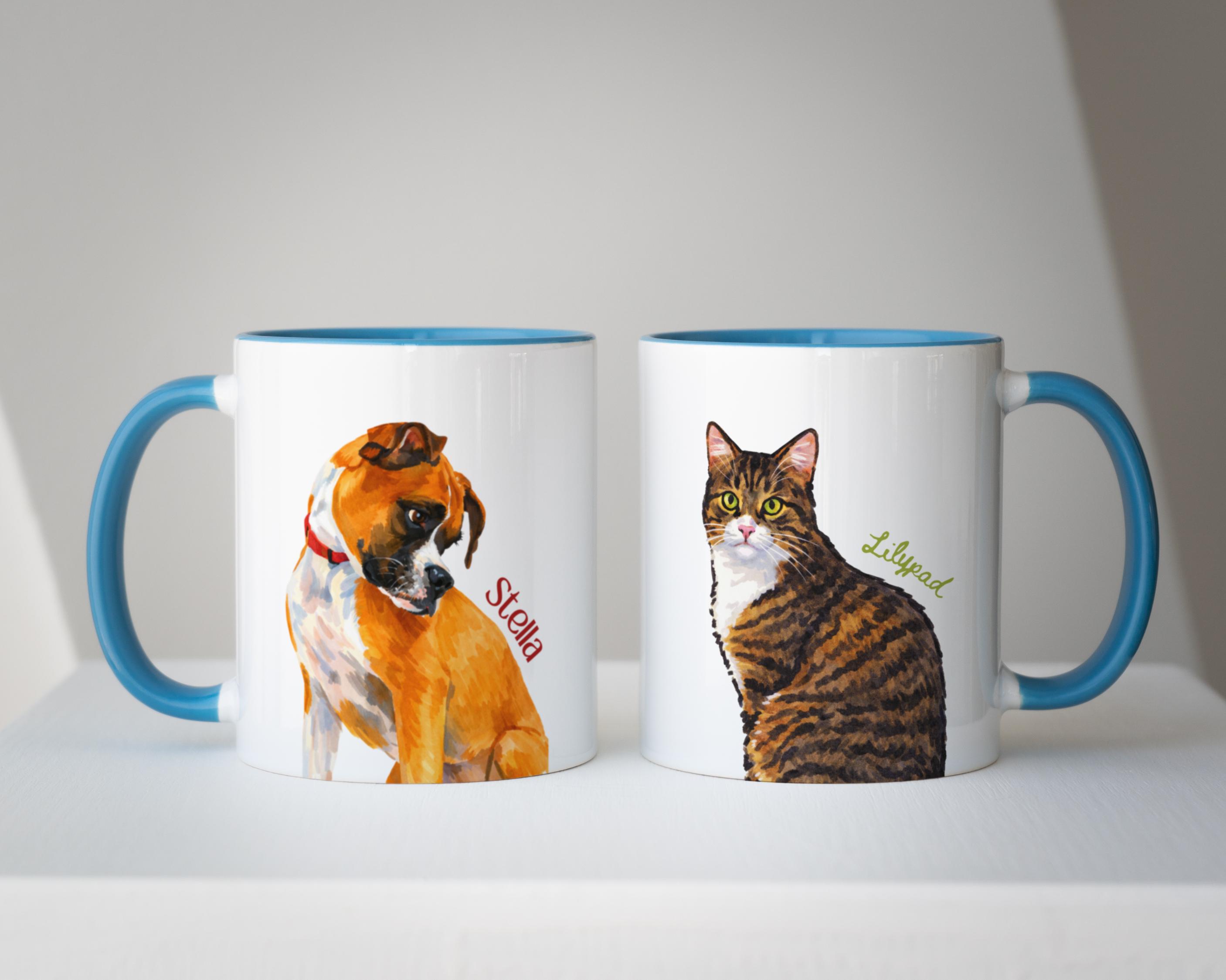 Two mugs with dog and cat illustrations on a white background