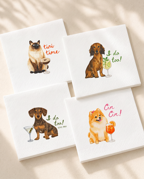 Four square white paper napkins with illustrated dog and cat cocktail-themed prints, arranged on a light beige surface with soft shadows.