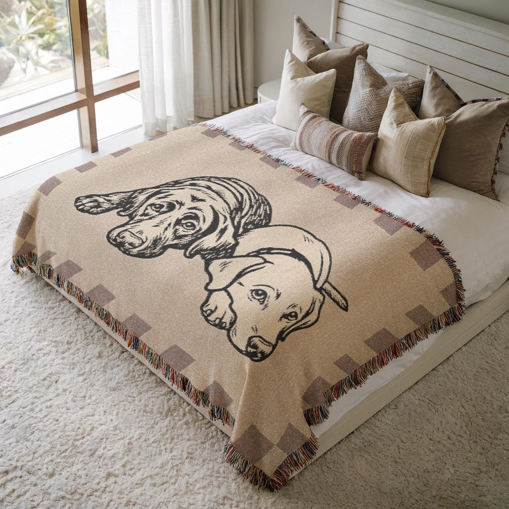 Beige blanket with dog illustration on a bed in a bedroom