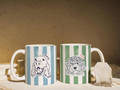 Two mugs with striped patterns and dog illustrations on a neutral background