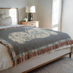 Gray patterned throw blanket on a bed in a bedroom setting