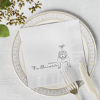 Cocktail napkin with bulldog illustration and 'The Oliver's' text on a place setting with plates and cutlery.