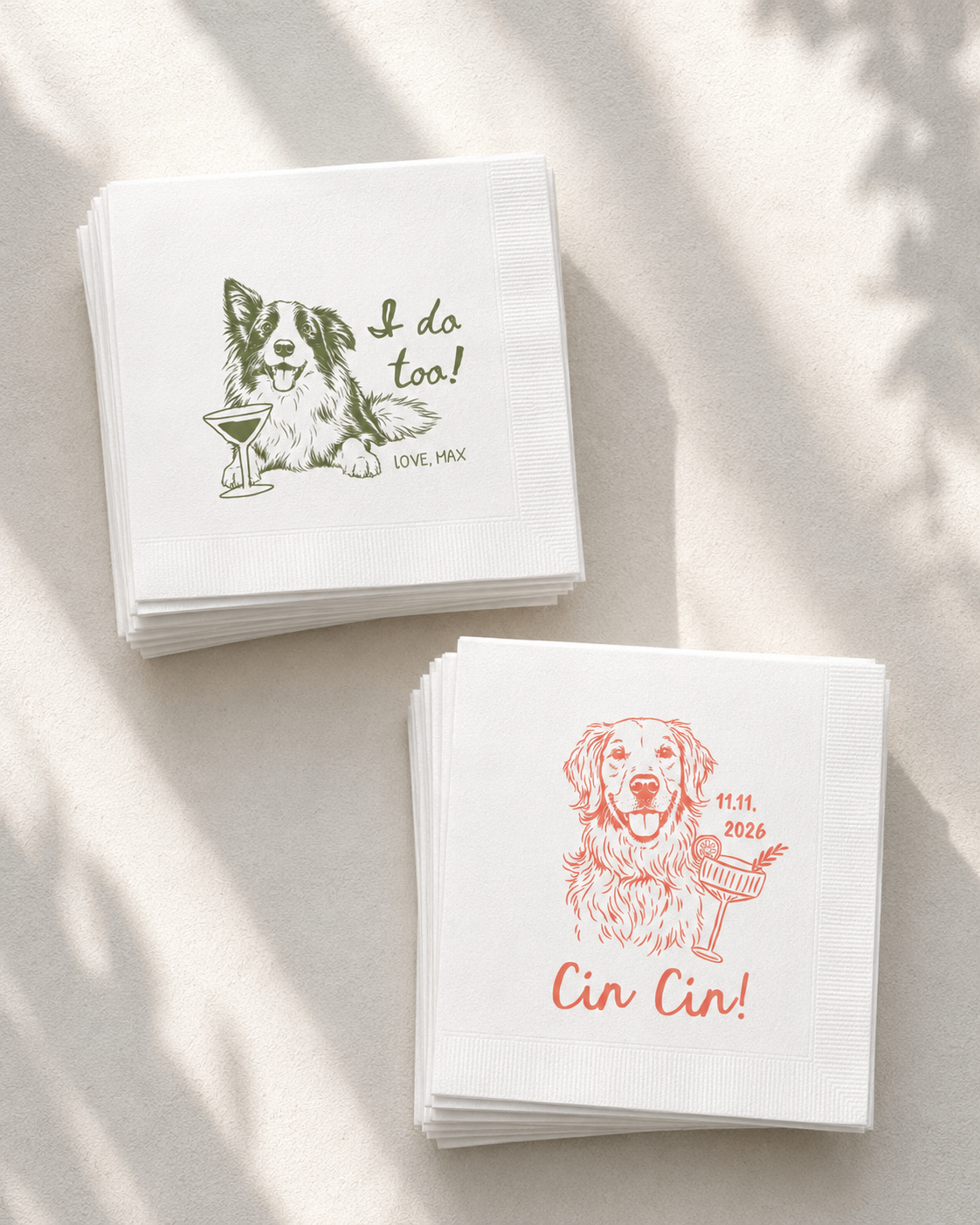 Two stacks of white cocktail napkins on a light beige surface with soft leaf shadows. One stack has a green dog illustration and the text 'I do too!' with 'LOVE, MAX' below.