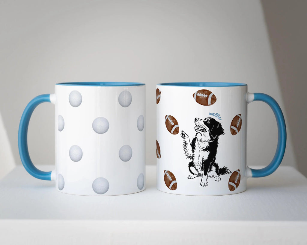 Two mugs with a blue accent handle and dog illustration with golf balls and footballs