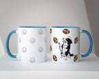 Two mugs with a blue accent handle and dog illustration with golf balls and footballs