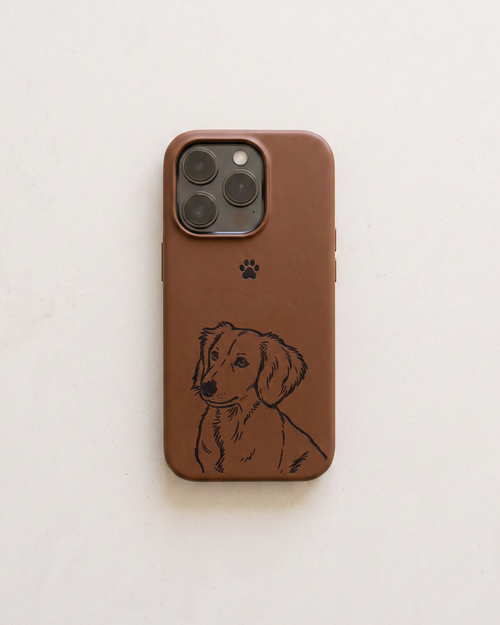 A brown leather phone case featuring a black line art illustration of a dachshund and a small black paw print, shown on a light beige textured background.