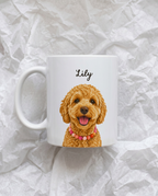 A white ceramic mug featuring a printed illustration of a smiling golden doodle dog wearing a pink beaded collar, with the name 'Lily' written above in black script. The mug is photographed on crumpled white paper.