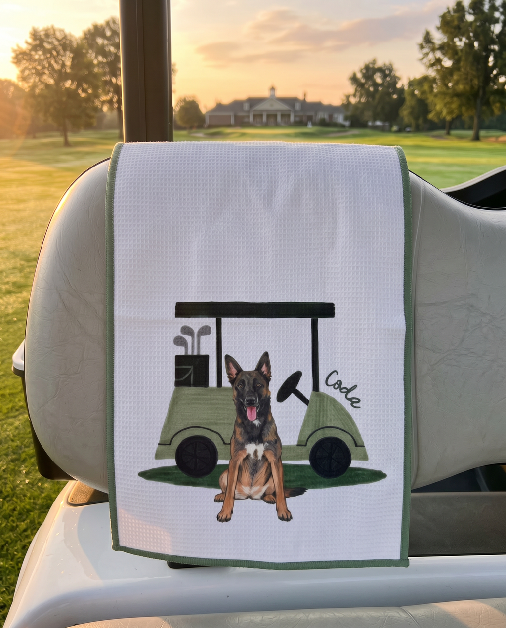 Golf towel with a shepherd dog and golf cart design on a golf cart