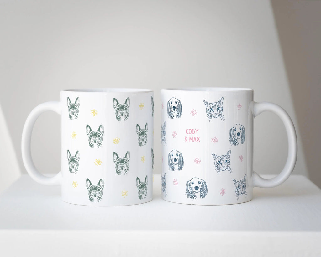 Two mugs with dog pattern designs on a white surface.