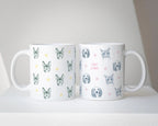 Two mugs with dog pattern designs on a white surface.