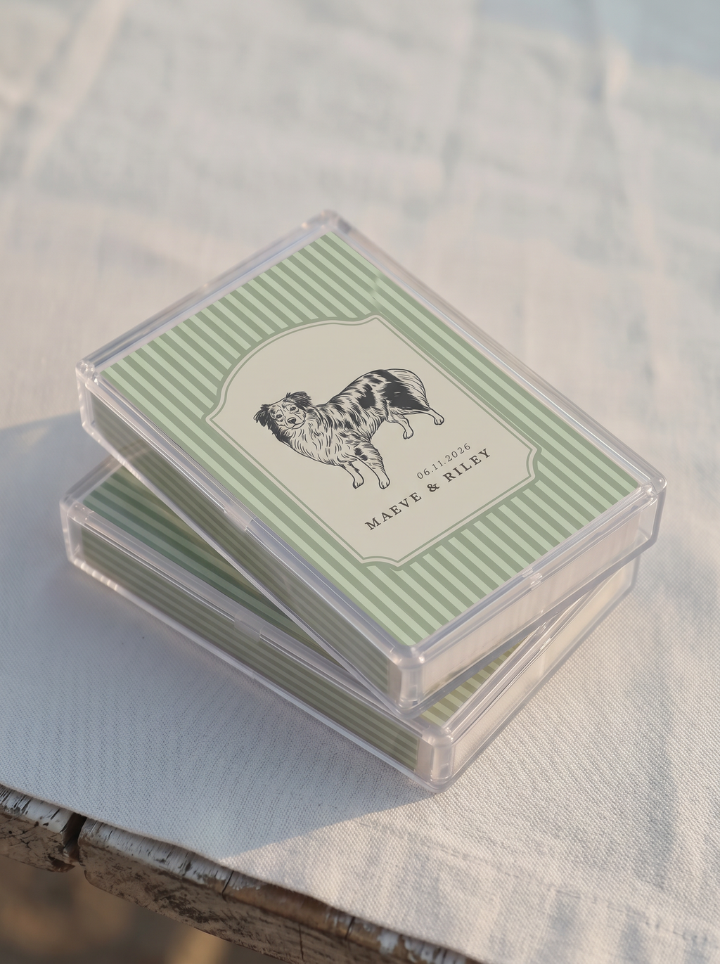 Stack of playing cards with a clear acrylic cover on a textured surface