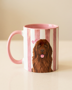 A white ceramic mug with pink stripes, a pink handle and interior, and a printed portrait of a brown long-haired dog. The name 'Beau' is written in pink script near the dog's head.