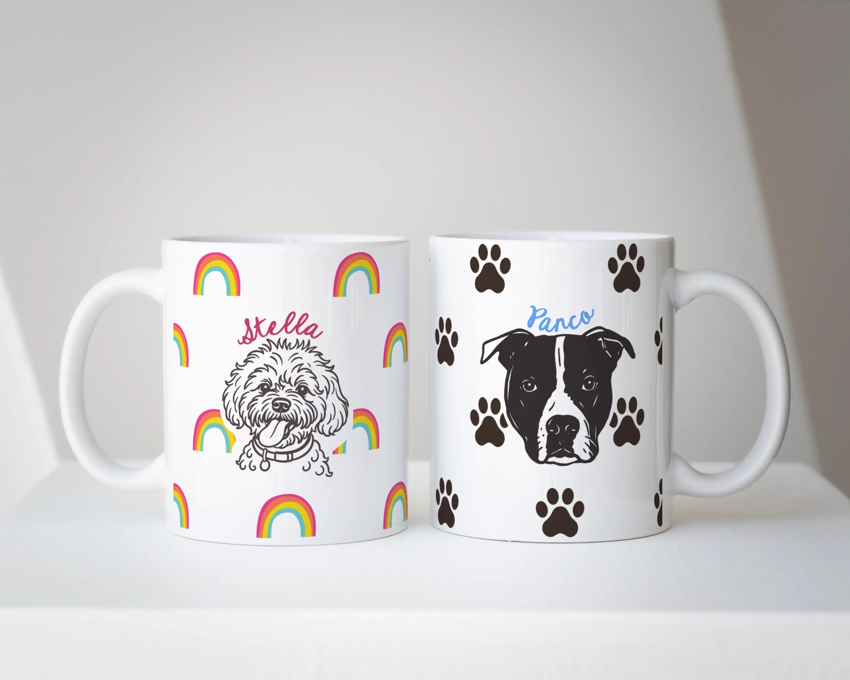 Two mugs with dog illustrations - custom dog mug with rainbows, and custom dog mug with paw icons and names on a white surface.
