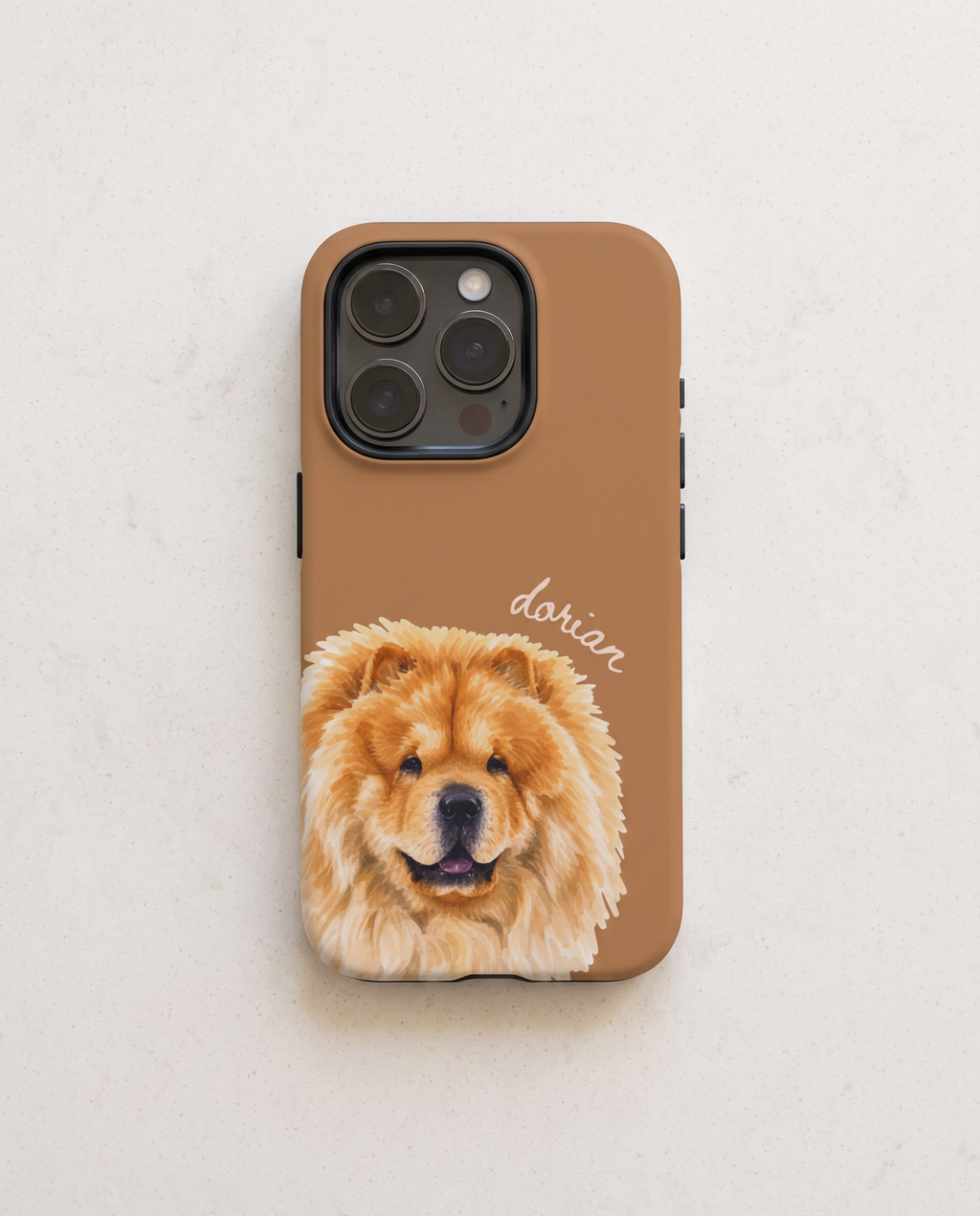 A brown phone case featuring a printed illustration of a fluffy golden Chow Chow dog and the name 'dorian' in white script, shown on a light beige textured background.